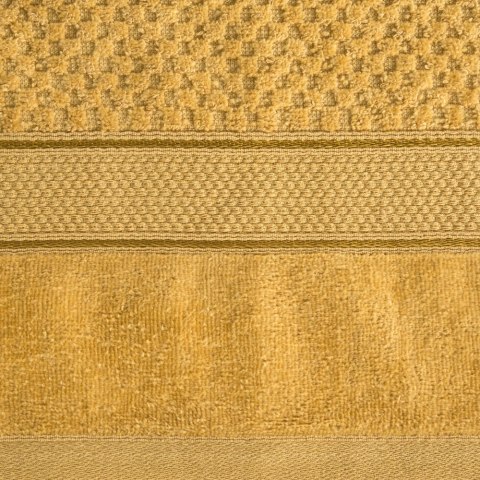 Ręcznik Jessi 70x140 musztardowy frotte 500g/m2 z fakturą wytłaczanej krateczki i welurową bordiurą Eurofirany Ręcznik Jessi 70x140 musztardowy frotte 500g/m2 z fakturą wytłaczanej krateczki i welurową bordiurą Eurofirany